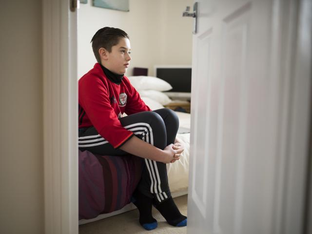 Boy sat alone in bedroom mental health 