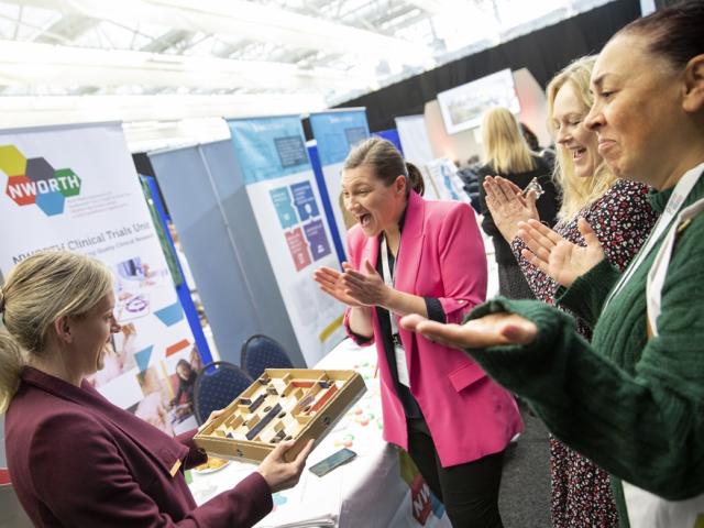 people chatting at a conference exhibit