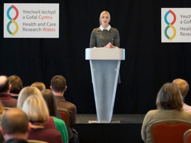 woman presenting at conference