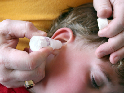 child having drops in ear 