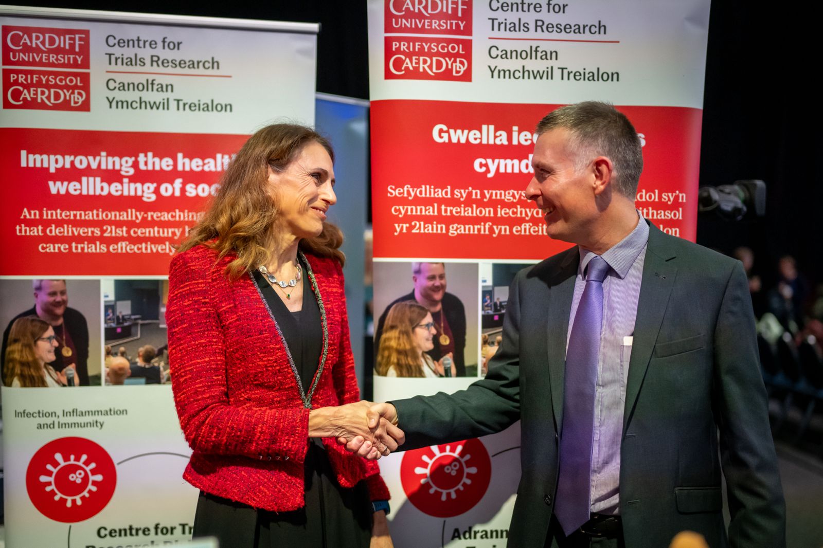 CMO for wales shaking hands with the winner of the best stand