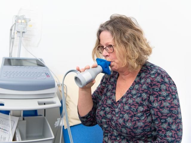 Woman taking lung capacity test