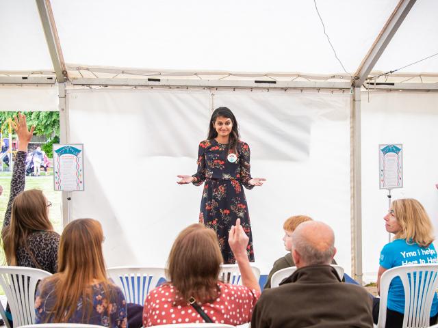 Woman answering questions in front of people