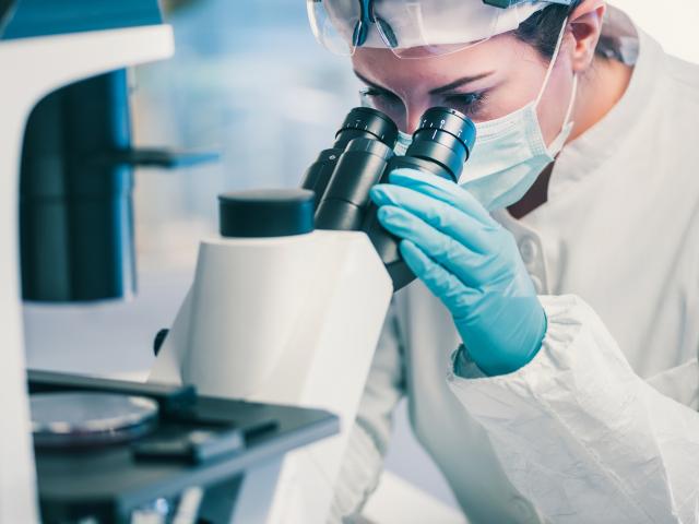 Woman looking through microscope