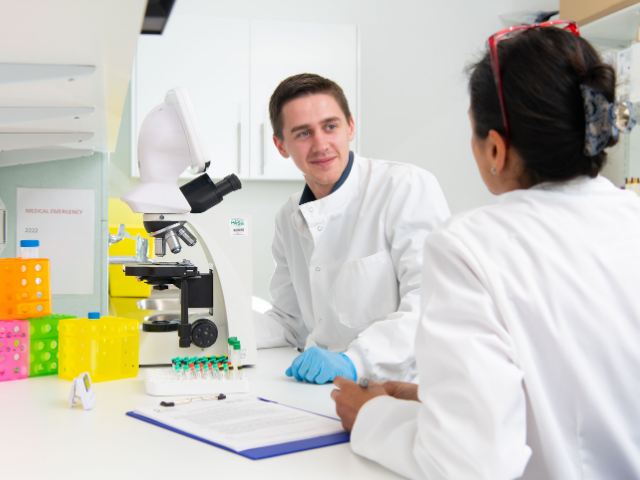 Two researchers talking in lab