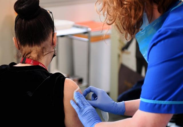 nurse preparing research participant for vaccine