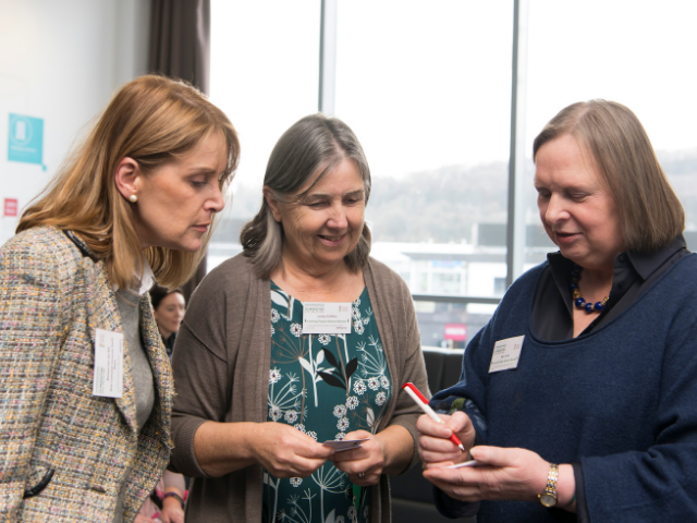 Three women talking at event