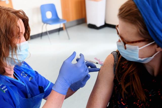 nurse injecting participant with vaccine