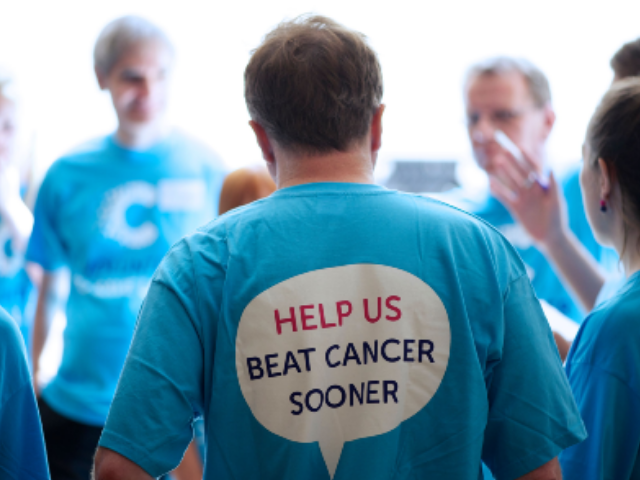 People in blue t-shirts that say help us beat cancer sooner