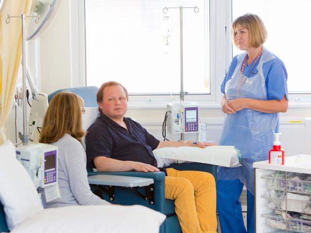 NHS Research Time Award research nurse with patient in arm chair 