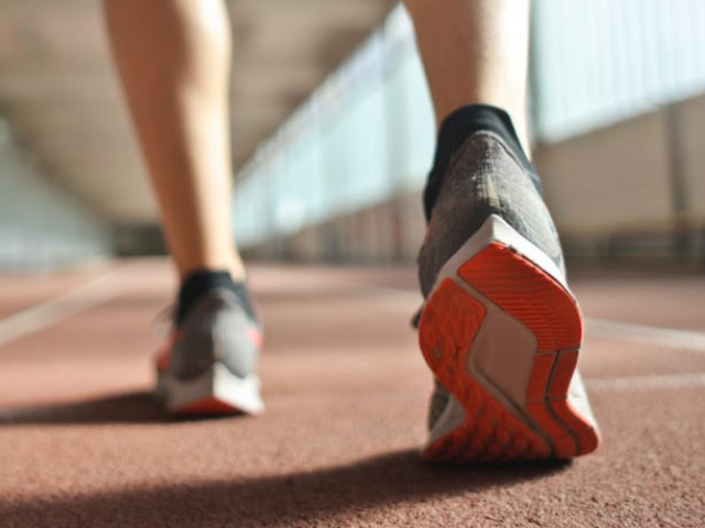 photo of person's heel wearing trainers