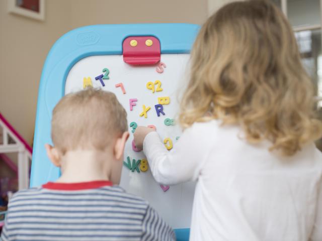 Children playing with magnet letters