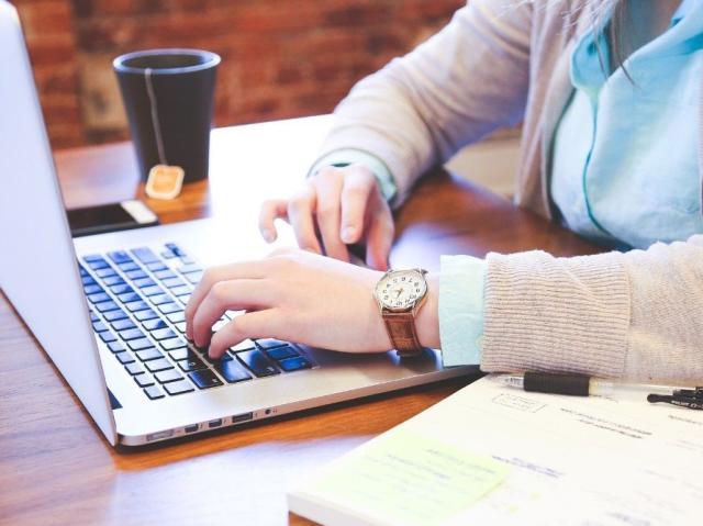 Person typing on laptop