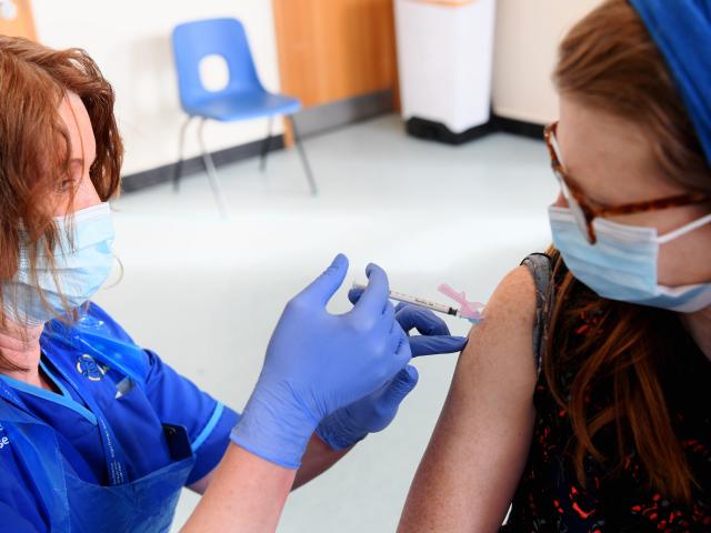 Woman receiving COVID-19 vaccination