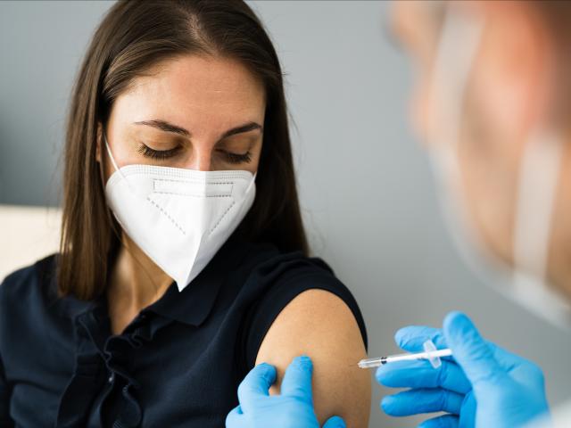 Woman receiving fourth dose of COVID-19 vaccine in COV-Boost trial
