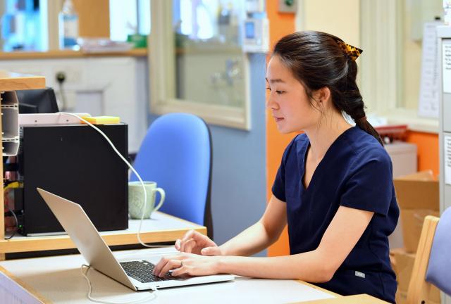 Research nurse working on laptop