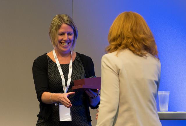 Woman receiving award at conference
