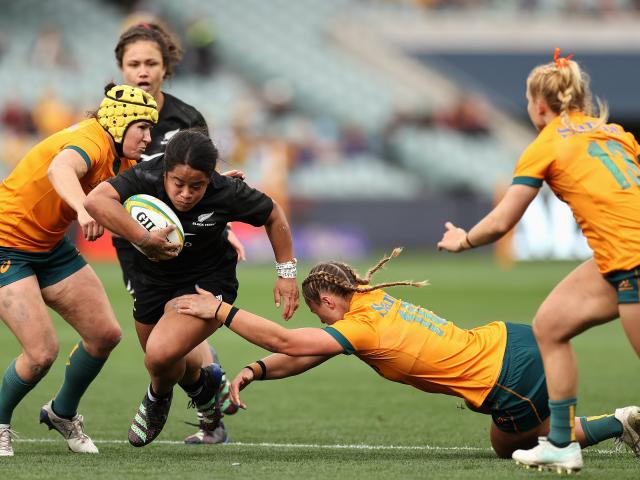 Women playing rugby.