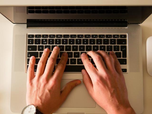 Hand typing on computer keyboard. 