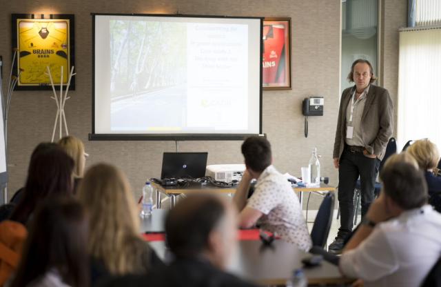 Researcher talking to a room of people