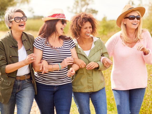 A four women in the nature, laughing. 