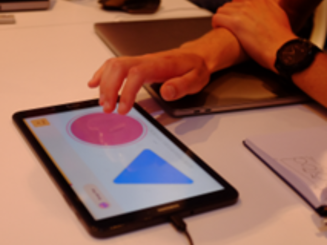 A blue triangle and a red circle on a tablet.