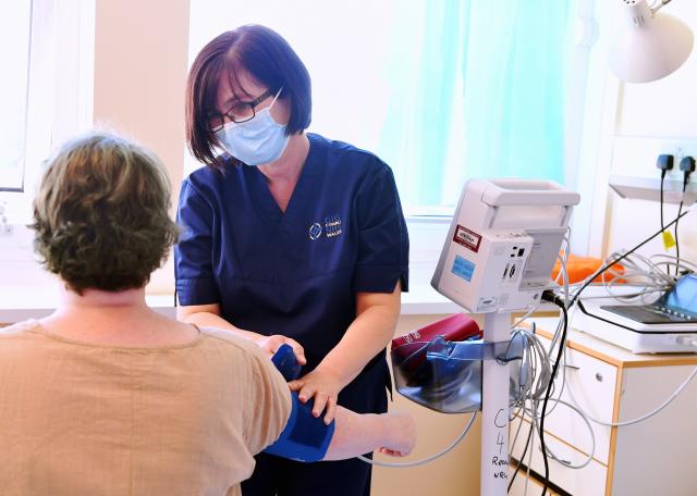 Research nurse taking blood pressure of patient