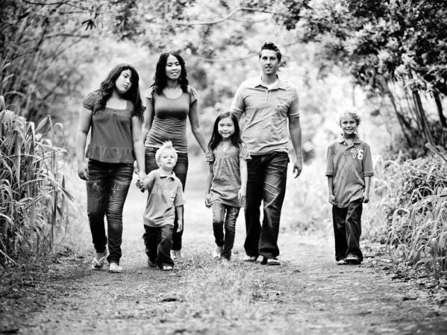 A family walking in the forest. 