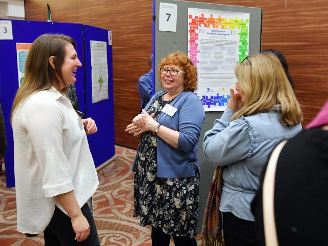 Attendees looking at posters