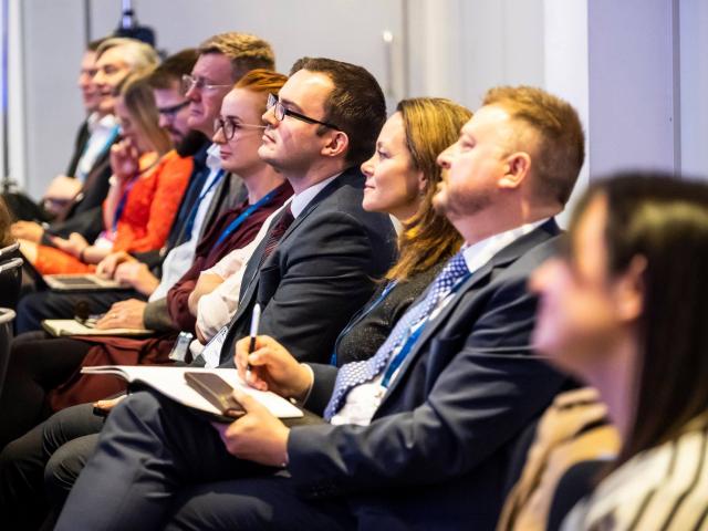 Conference attendees listening to a talk