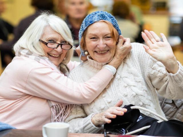 Two elderly ladies smiling at the camera