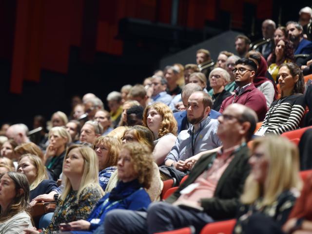 Conference delegates watching a speech