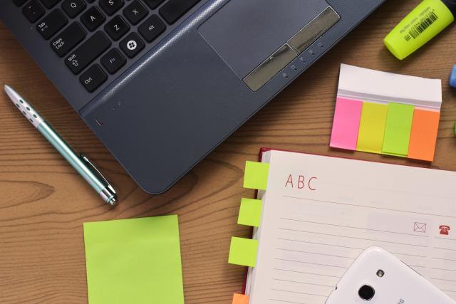 a notebook and some notepads on a desk