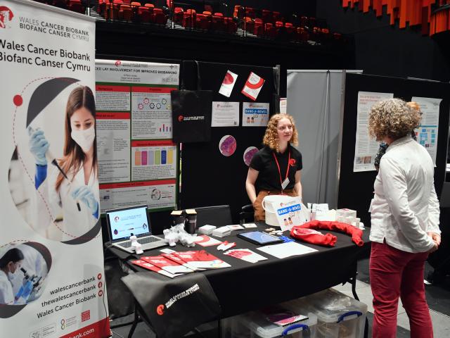 Two women talking at an exhibition stand