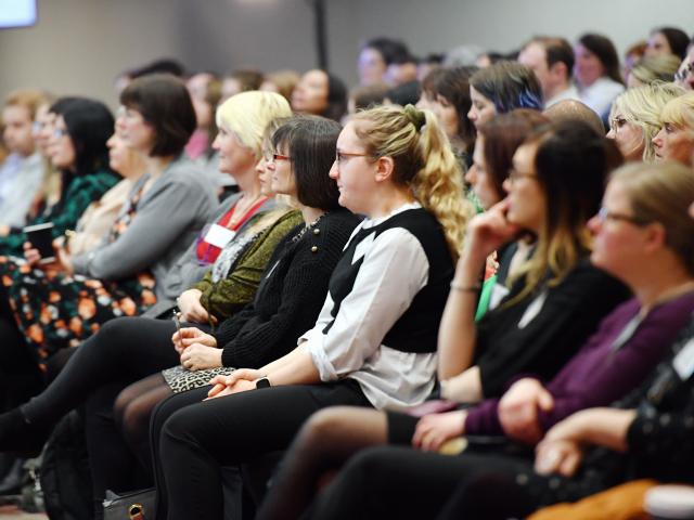 Delegates watch a presentation