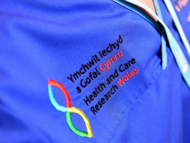Health and Care Research Wales logo on nurses uniform