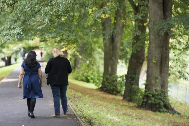 two women walking in the wood