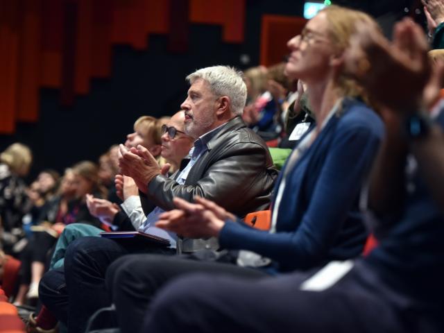 Audience applauding speaker