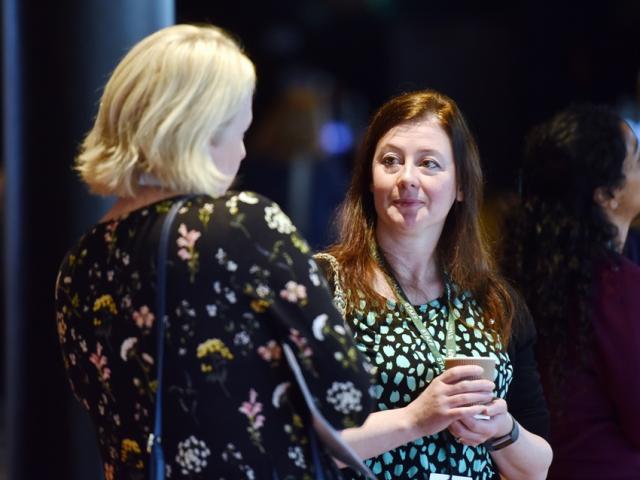 Delegates talk at an exhibition