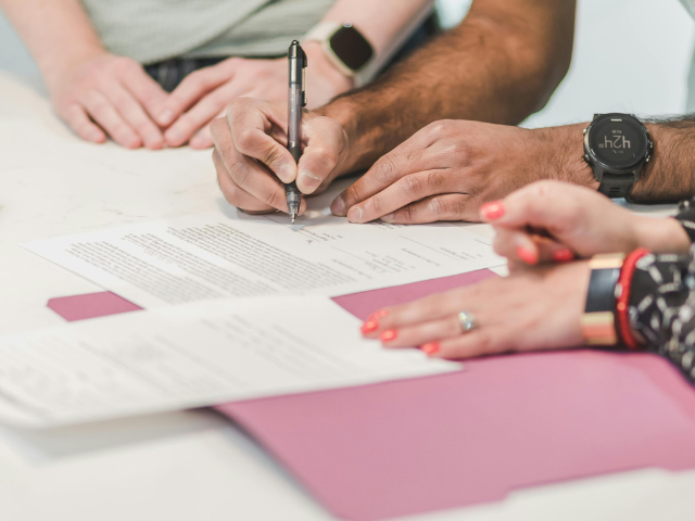 A woman filling in documents. 