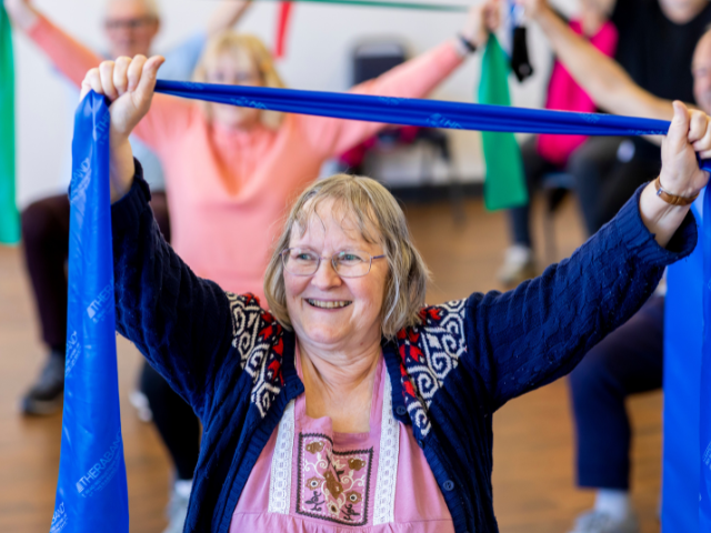 Older woman using a resistance band to exercise