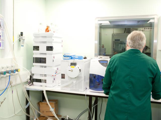 man in a green laboratory coat in a laboratory 