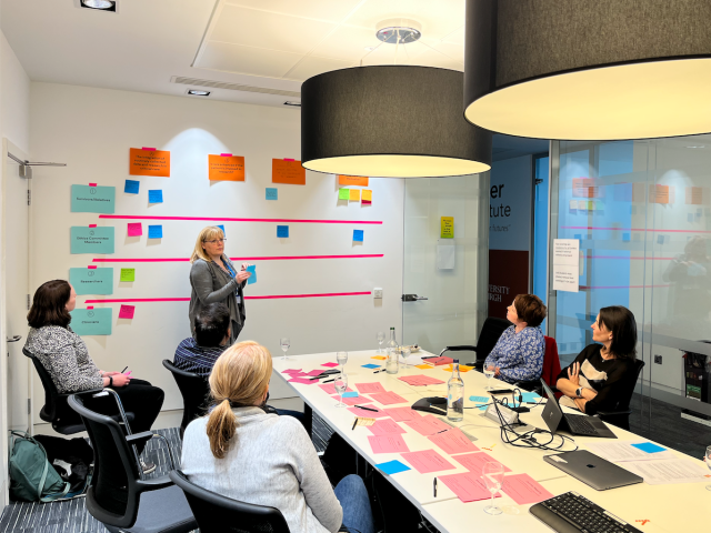 Researchers and public co-designing in a room.