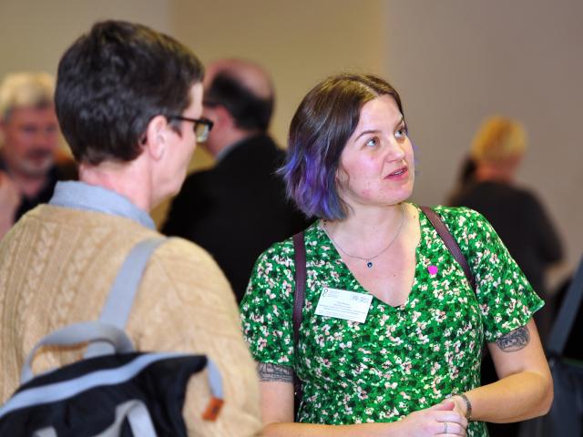 people chatting at a conference exhibit