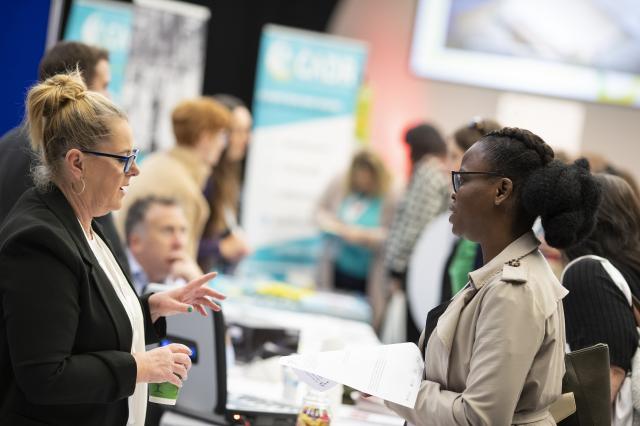 Two women discussing health and care research