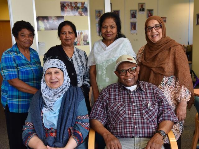 six people of mixed ethinc background looking directly at the camera