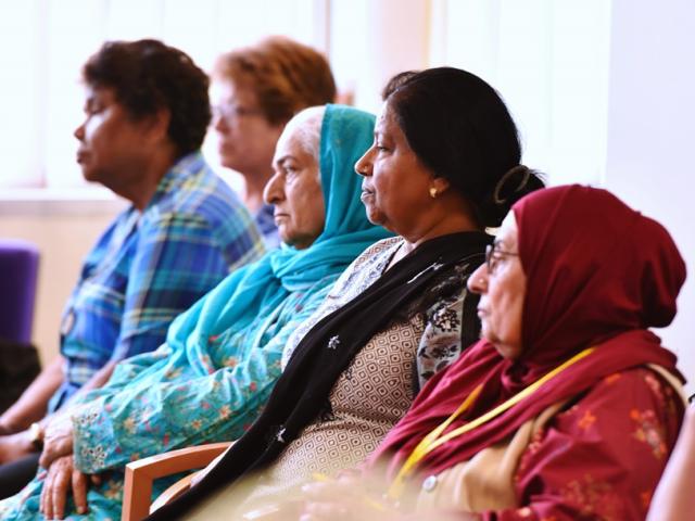 five women attending a talk