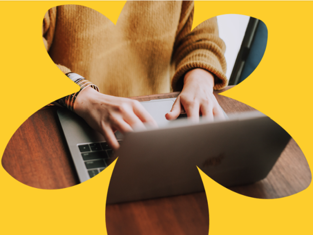 Cut out of sunflower with picture of person typing on laptop
