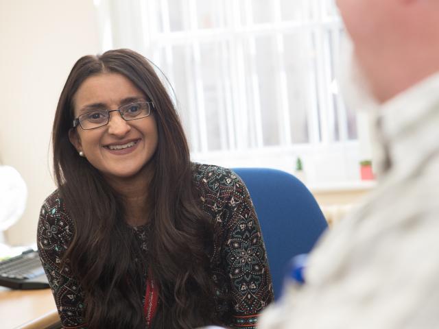 a_woman_wearing_glasses_smiling