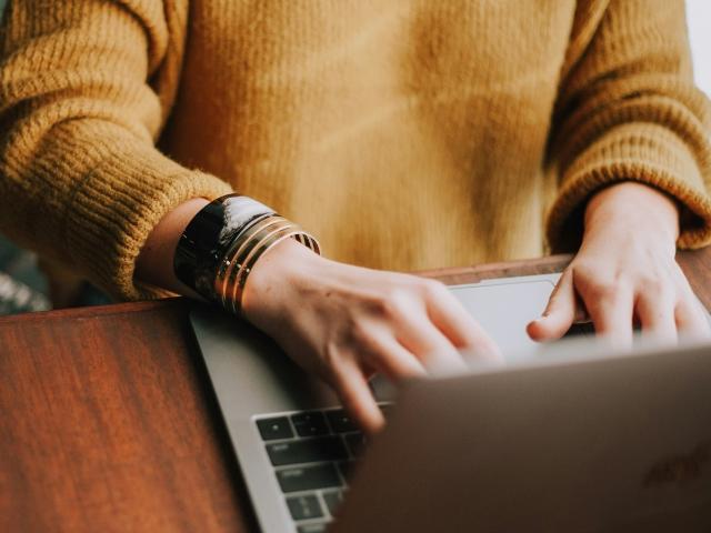 a_person_typing_on_a_laptop